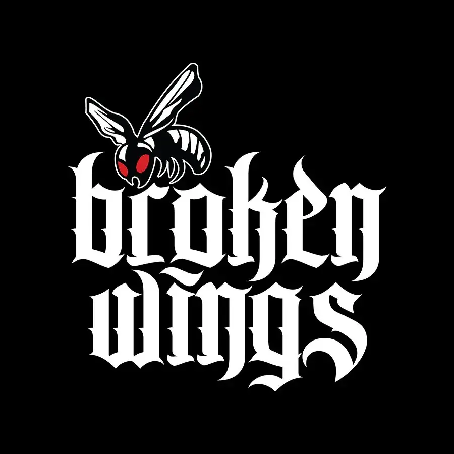 Broken Wings logo: blackletter wordmark beneath a wasp, white on black.
