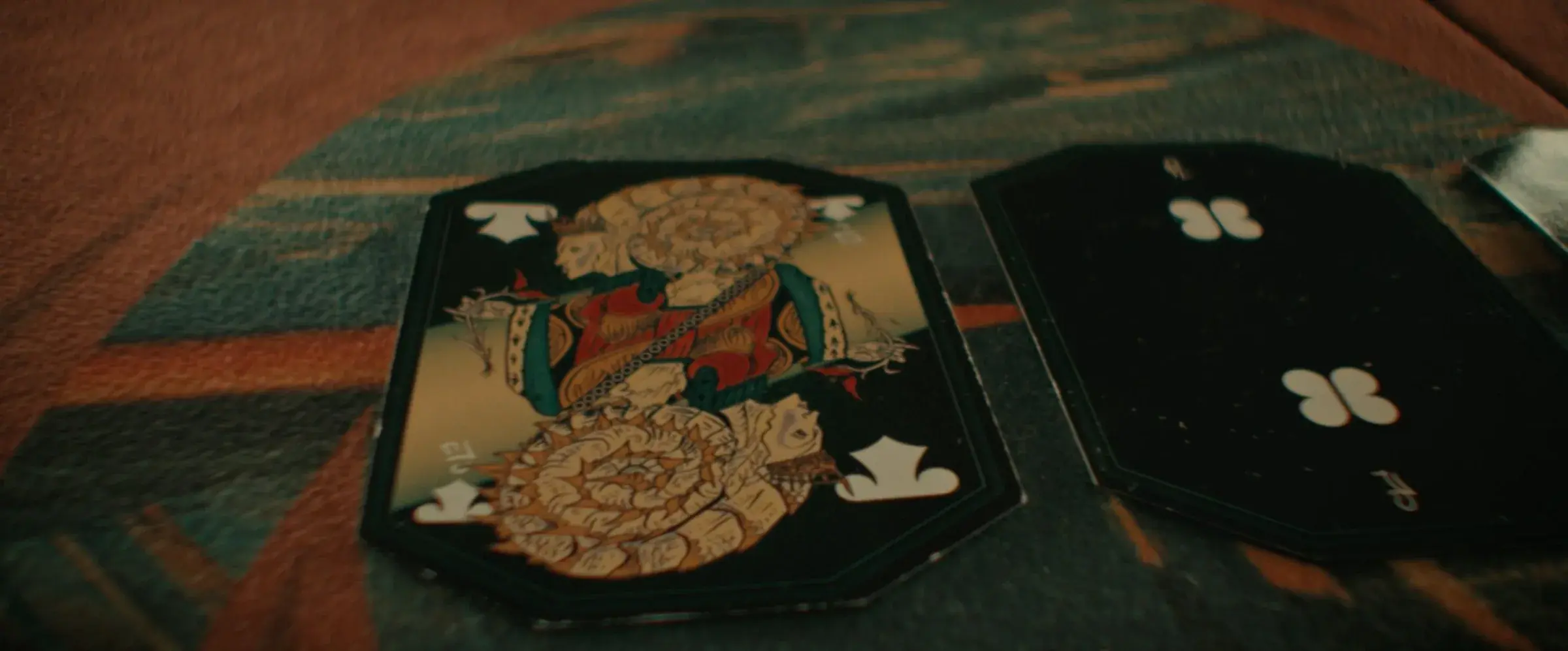 A close-up frame from Star Trek: Discovery showing custom playing card props on a table.