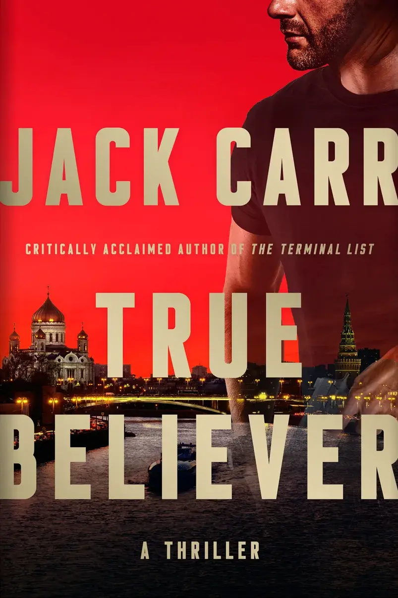 Cover of Jack Carr's novel True Believer: a man in silhouette against a red sky over a city skyline