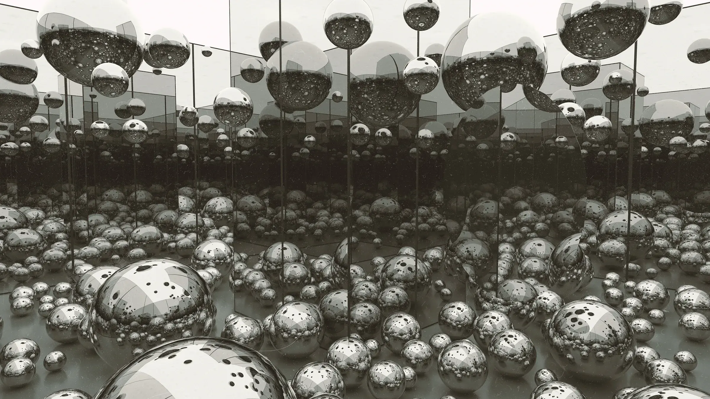 An endless grey field of chrome spheres beneath floating mirrored discs.